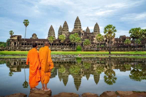 Asian monks looking at Angkor Wat in Siem Reap, Cambodia
