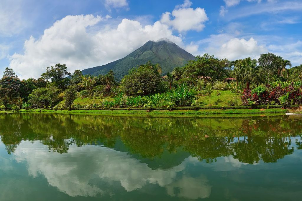 Arenal Volcano reflecting on the lake in La Fortuna, Costa Rica