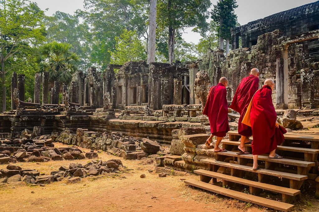 Buddhist monks entering Bayon Temple at Angkor Wat, Siem Reap, Cambodia