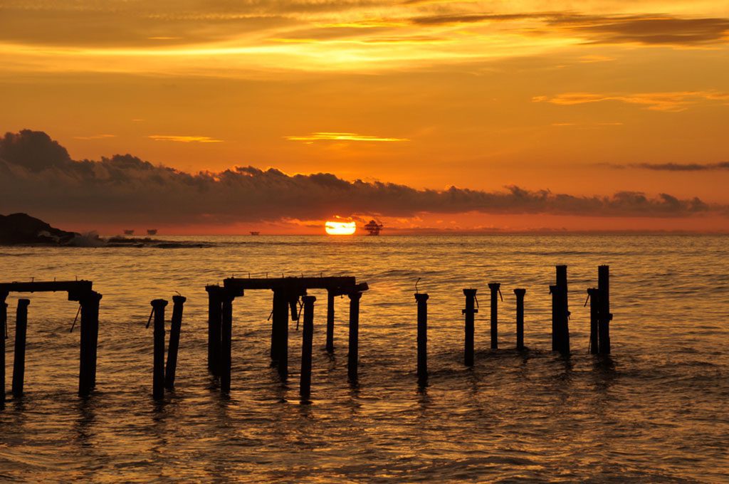 "Old dock irons of old pier in Lobitos beach in Piura with a spectacular sunset in the background by Carlos Sala Fotografia