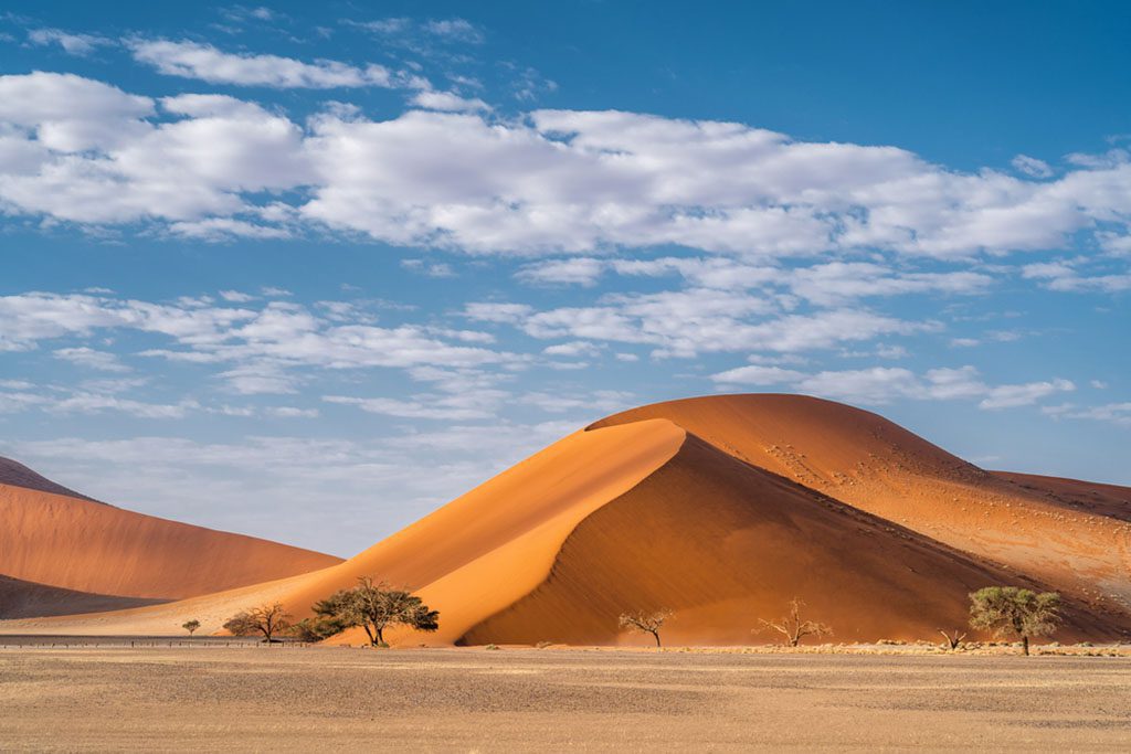 A stunning aerial view of towering sand dunes around Sossusvlei in the Namib-Naukluft National Park, Namibia, Africa.
