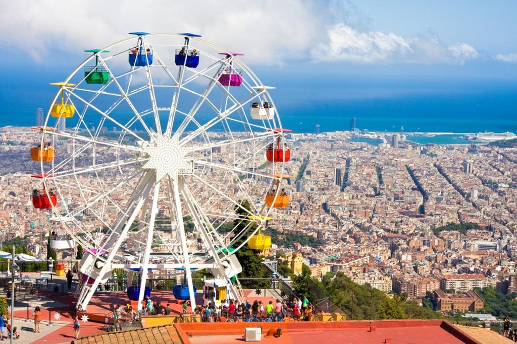 Ferris wheel in Tibidabo with panoramic view over Barcelona