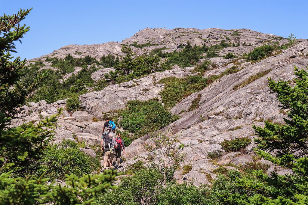 Hikers ascending Mount Monadnock at Monadnock State Park in New Hampshire