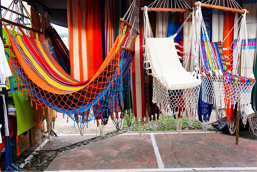 Colorful handmade handicrafts in Indian market of Otavalo in Ecuador