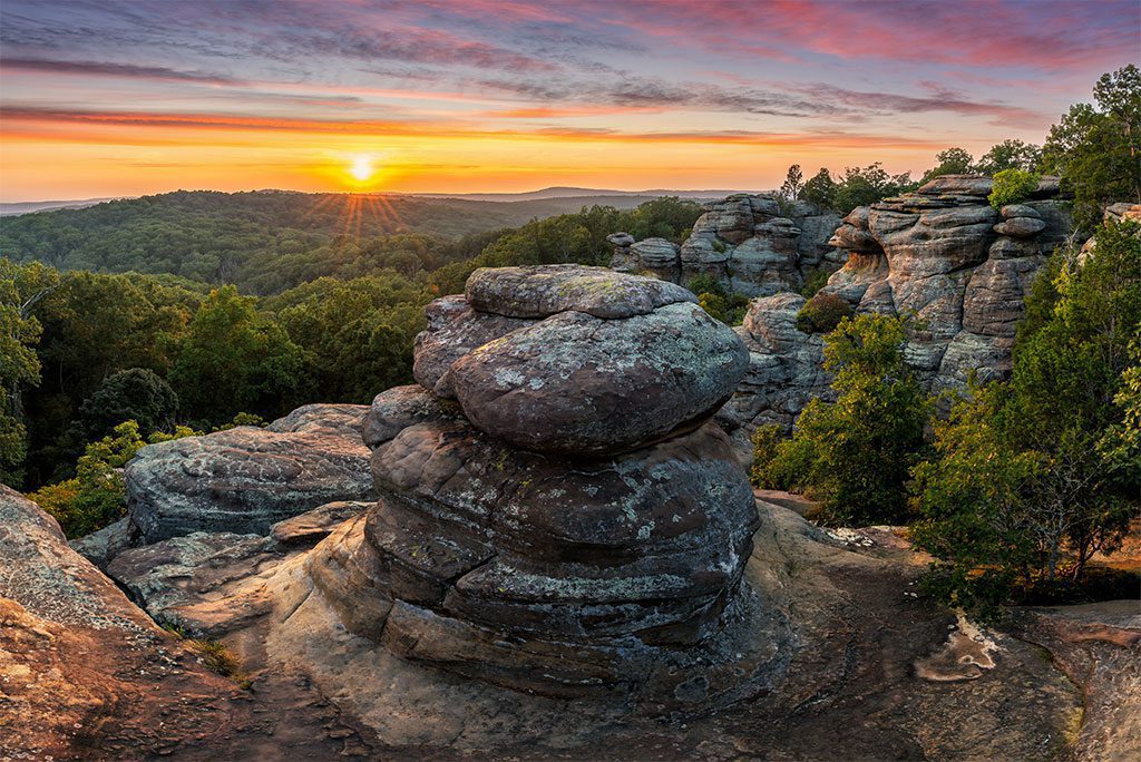 A panoramic view of a beautiful natural rock formation in a forest.