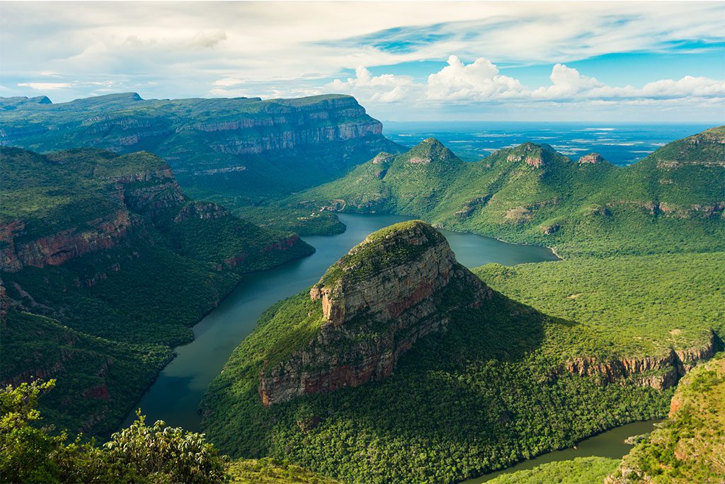 Blyde River Canyon 3 - A stunning view of the Blyde River Canyon in South Africa with lush greenery and misty mountains in the background.