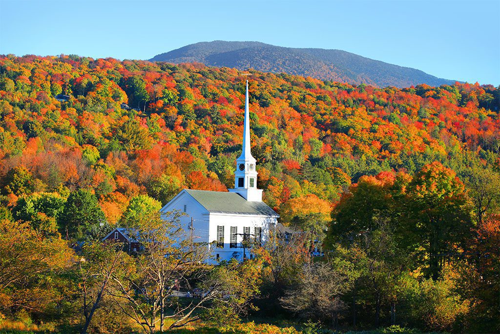 A church with mountains in the background.