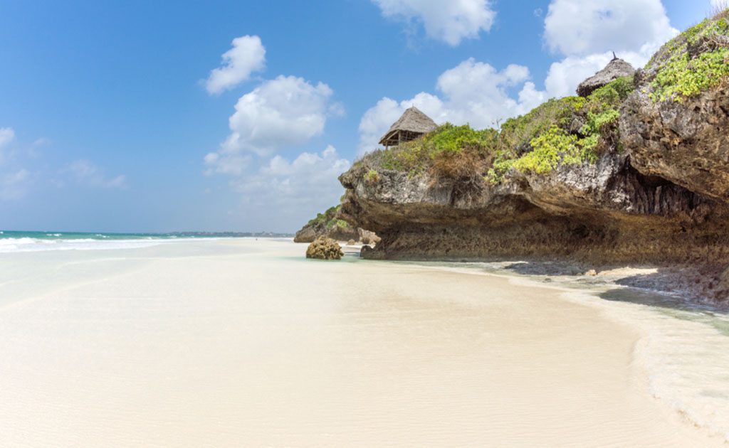 Kilifi white sand beaches in Kenya, with palm trees and clear blue sea water.