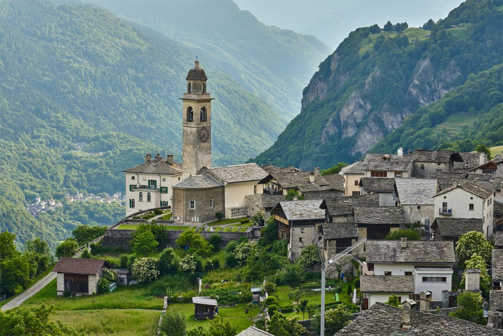 Landscape panorama of church and old houses of mountain village Soglio, canton of the Grisons, Switzerland