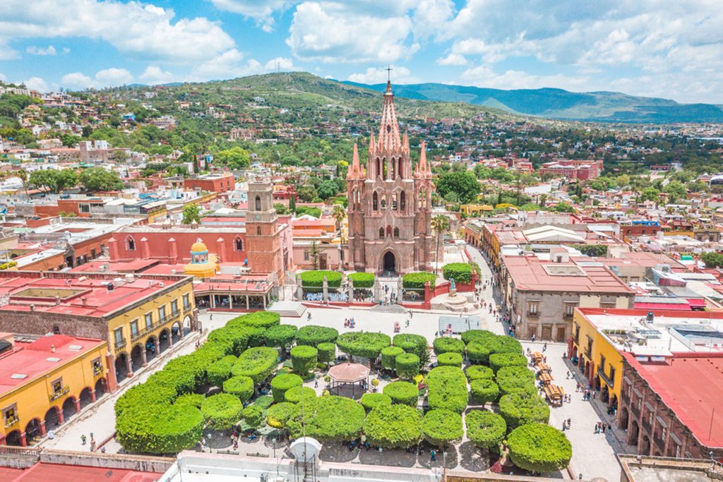 Aerial view of the main square of San Miguel de Allende in Guanajuato, Mexico with colorful buildings and a churc