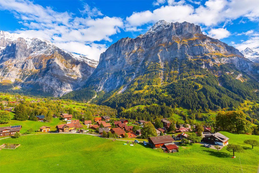 Aerial view of Grindelwald village and the Swiss Alps in autumn.