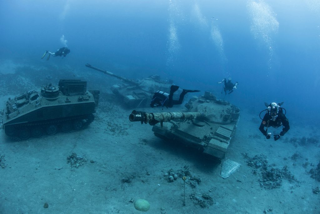 Underwater view of armored vehicles, tanks, and military equipment