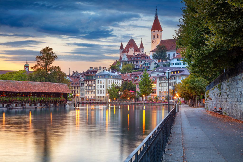 Cityscape of Thun, Switzerland with reflection in Aare river at sunset