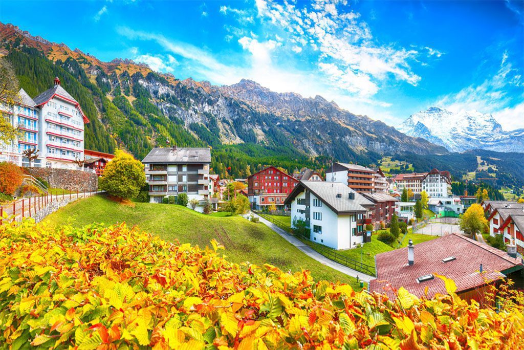 Stunning autumn view of picturesque alpine village Wengen with Jungfrau Mountain and Lauterbrunnen Valley on background.