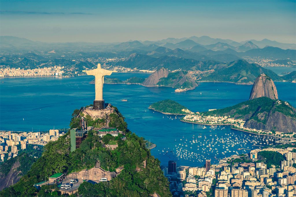 Panoramic view of Botafogo Bay with Christ the Redeemer and Sugar Loaf Mountain in Rio de Janeiro, Brazil. 