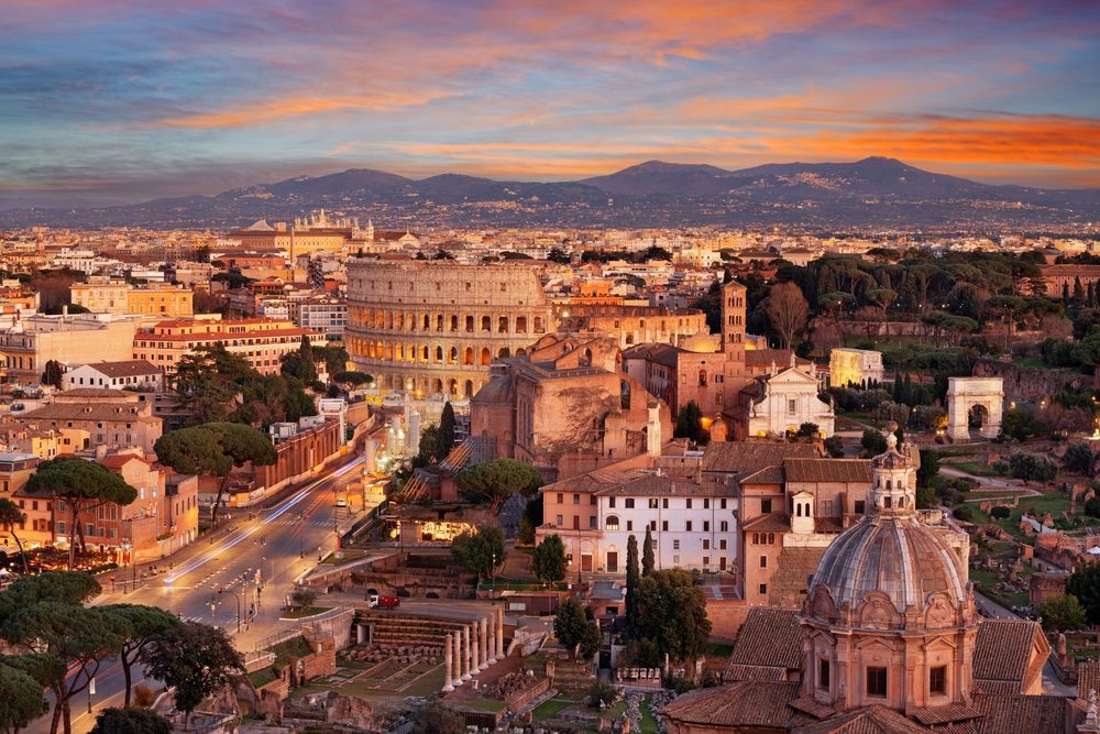 View towards the Colosseum with archeological areas at sunset in Rome, Italy