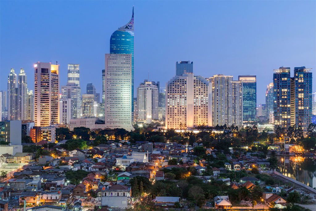 Jakarta downtown skyline with high-rise buildings at sunset.