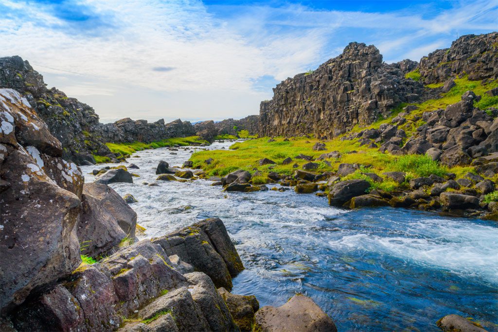 Turbulent water flow downstream from a waterfall in Thingvellir National Park in Iceland.