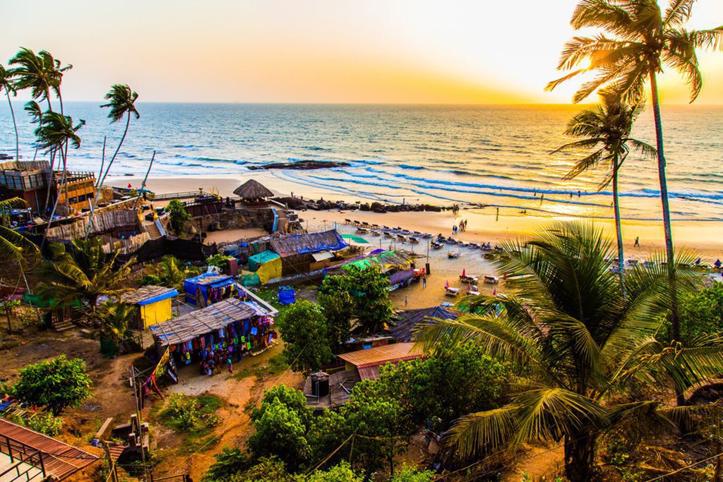 Sunset on palm beach in Goa, India