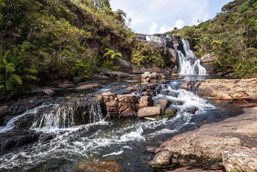 A waterfall flowing through the rocks in Horton Plains National Park, Sri Lanka