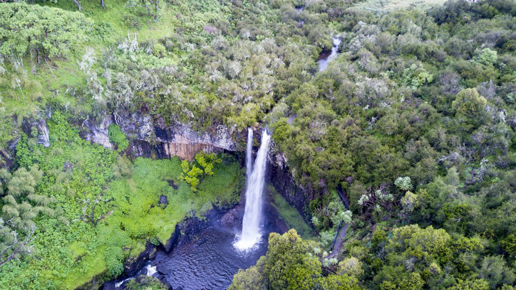 Aerial view of waterfall surrounded by lush green vegetation in Aberdares National Park, Kenya