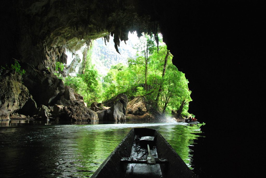 A scenic boat ride through the Kong Lor Cave, a natural wonder in central Laos.