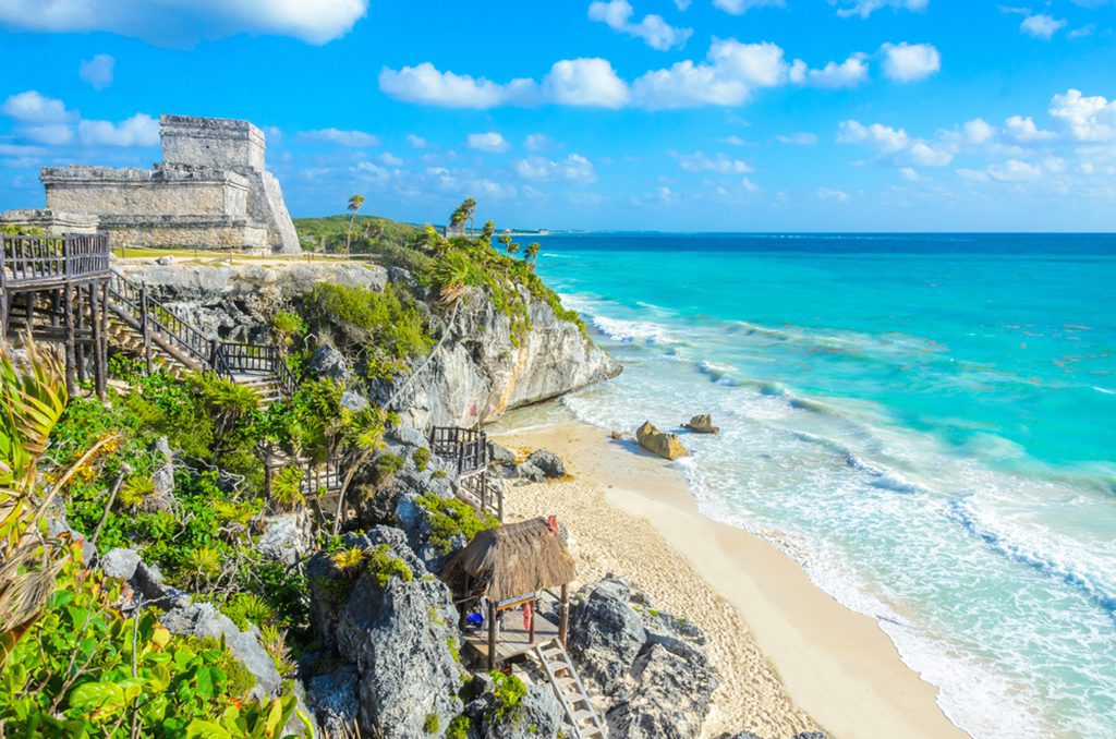 Aerial view of Mayan ruins on the tropical coast.