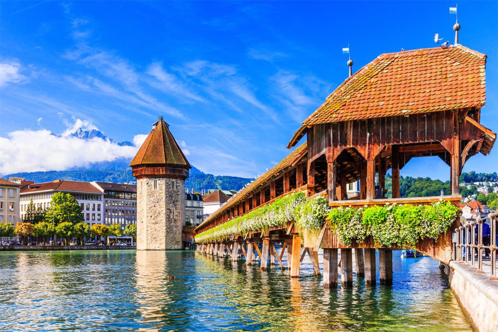 Historic city center of Lucerne, Switzerland with Chapel Bridge and Mt. Pilatus in the background