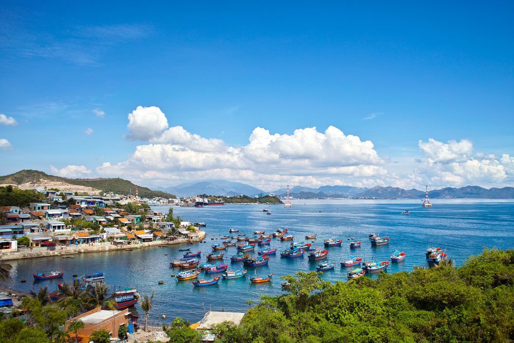 Scenic view of Nha Trang, a coastal city in Vietnam, with blue sky and crystal clear water.