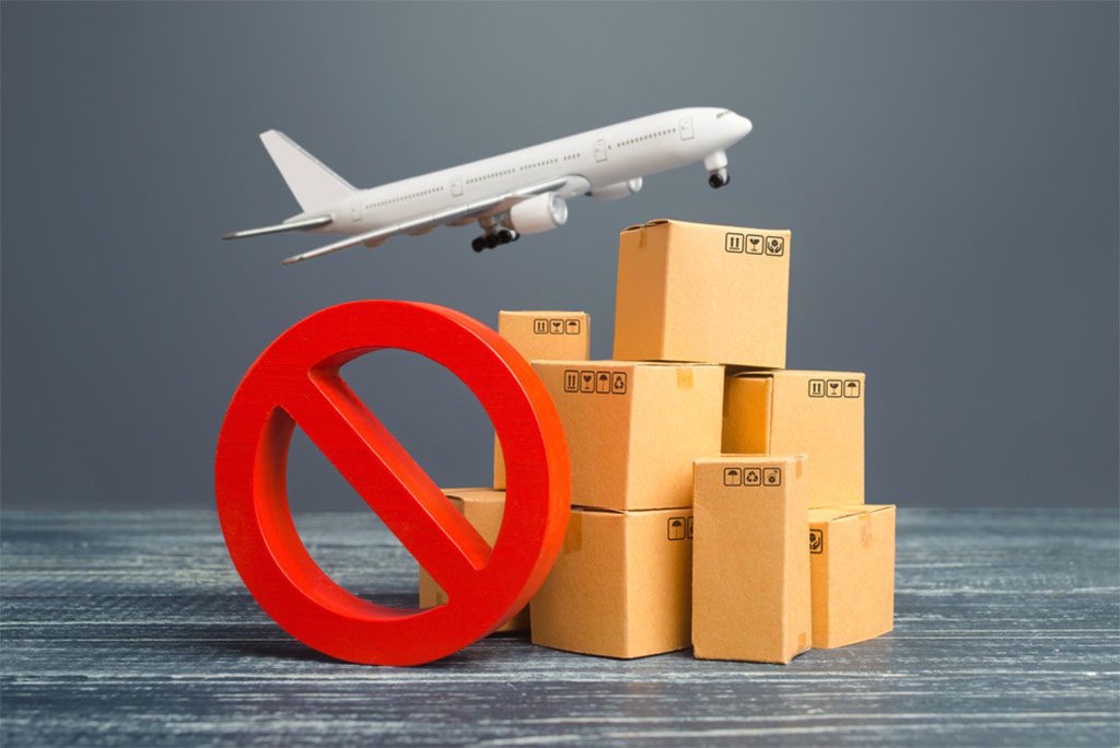 Stacked cardboard boxes with a red prohibition symbol, representing out-of-stock items or trade restrictions."