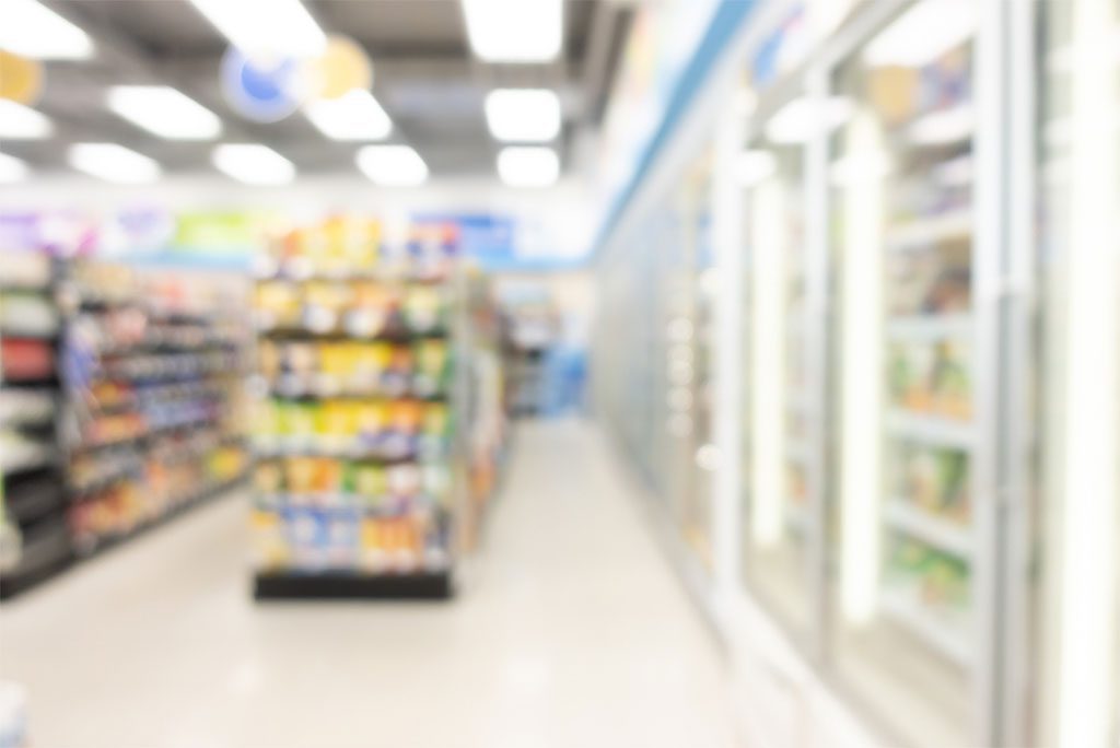 Blurred shelves in a minimart and supermarket, creating an abstract background