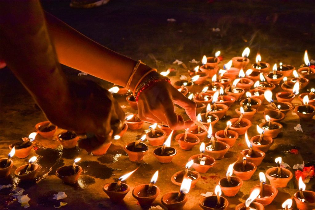 Diya lamps illuminating the Diwali festival in India, symbolizing the joy and warmth of the celebration.