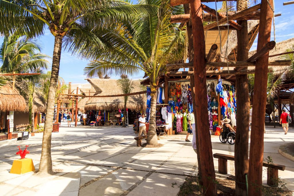 Costa Maya cruise ship terminal and resorts with palm trees and clear blue waters"
