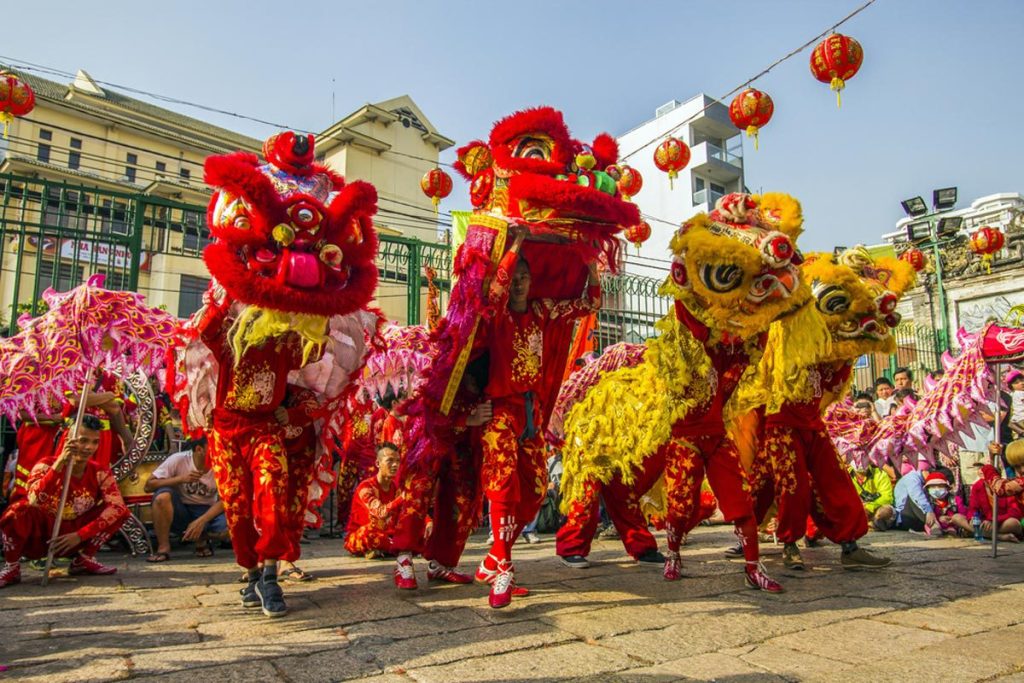 Dragon and lion dancers performing a mesmerizing show during the Chinese New Year festival in Saigon, Vietnam.