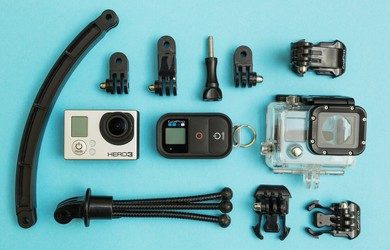 GoPro Hero 3 camera and accessories on a blue background