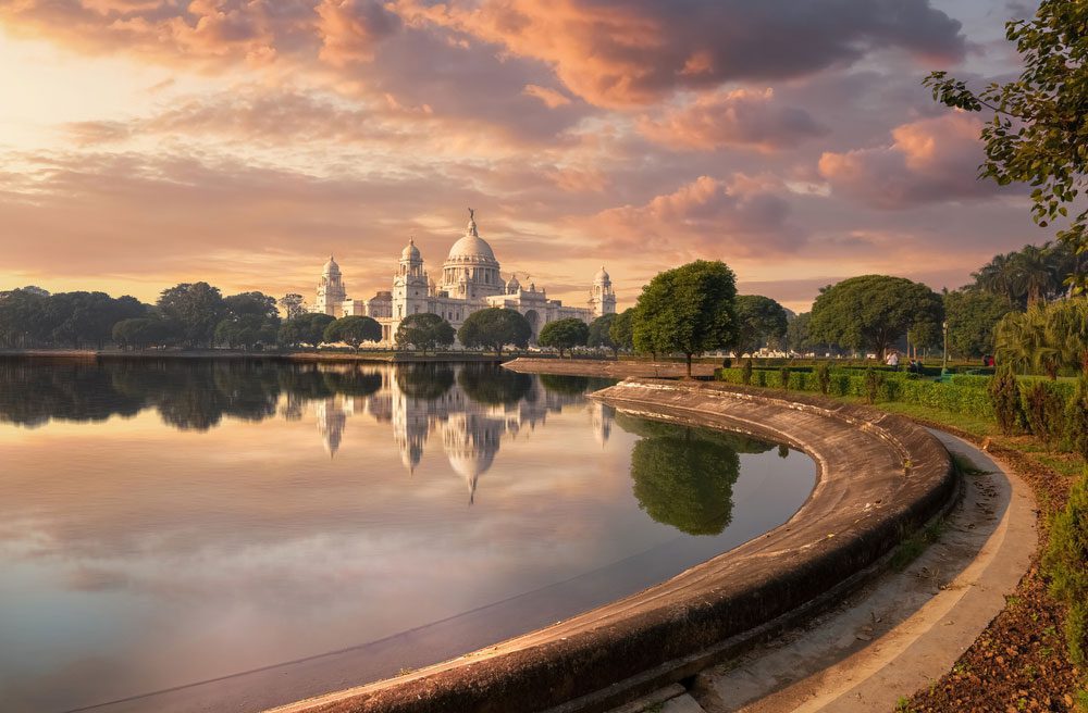 Captivating sunset view of Victoria Memorial Kolkata with adjoining garden and lake - 5 Best Places to Visit in Kolkata