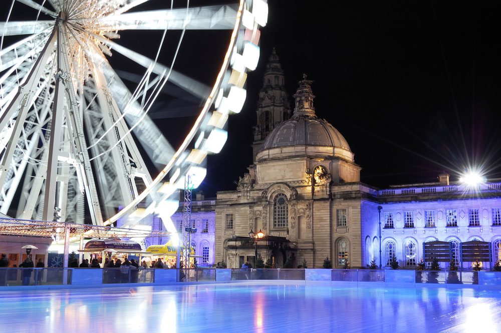 Empty ice rink and winter wonderland in Cardiff, with City Hall in the background.