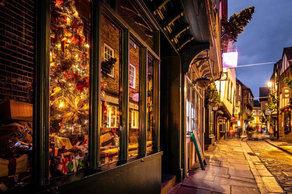 Christmas night view of Shambles, a historic street in York with medieval timber-framed buildings, UK.