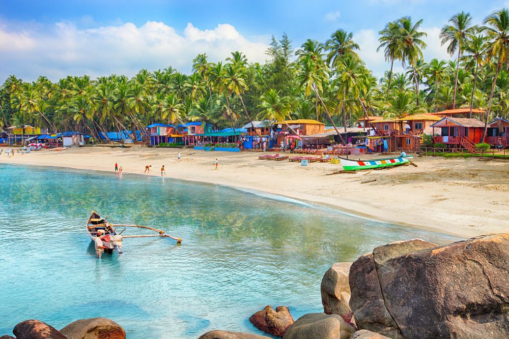 Idyllic Goa beach with fishing boats and sea stones, highlighting the best places to visit in Goa in 3 days