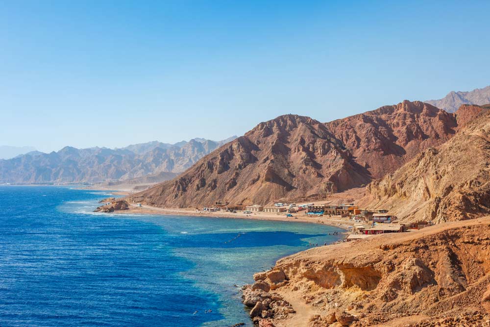 Sunny resort beach at the coast shore of Red Sea in Dahab, Sinai, Egypt, Asia in summer hot.